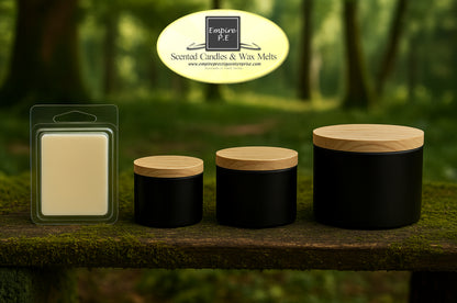 Assorted black candle jars with wood lids and a wax melt pack on a rustic wooden surface outdoors